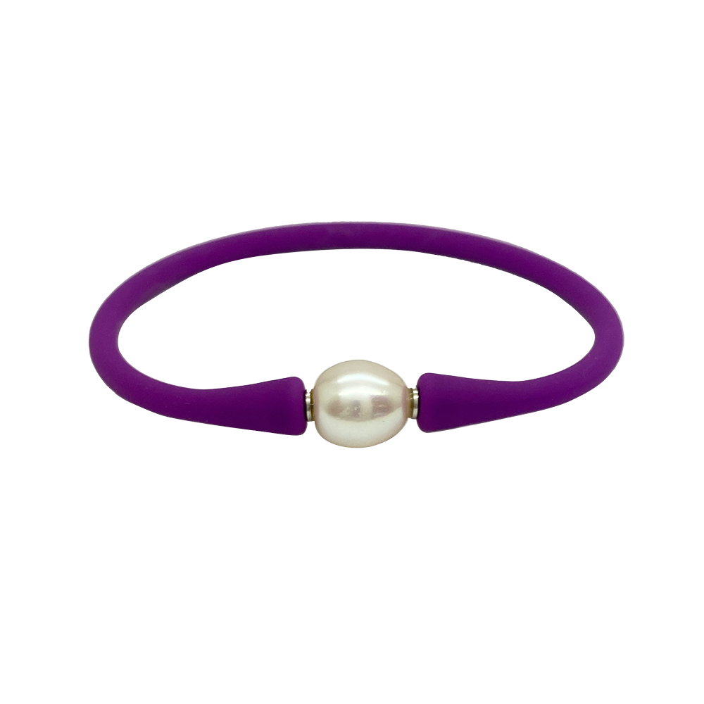 Bracelet with a single white pearl in the center. The bracelet is made of a rubber-like material .