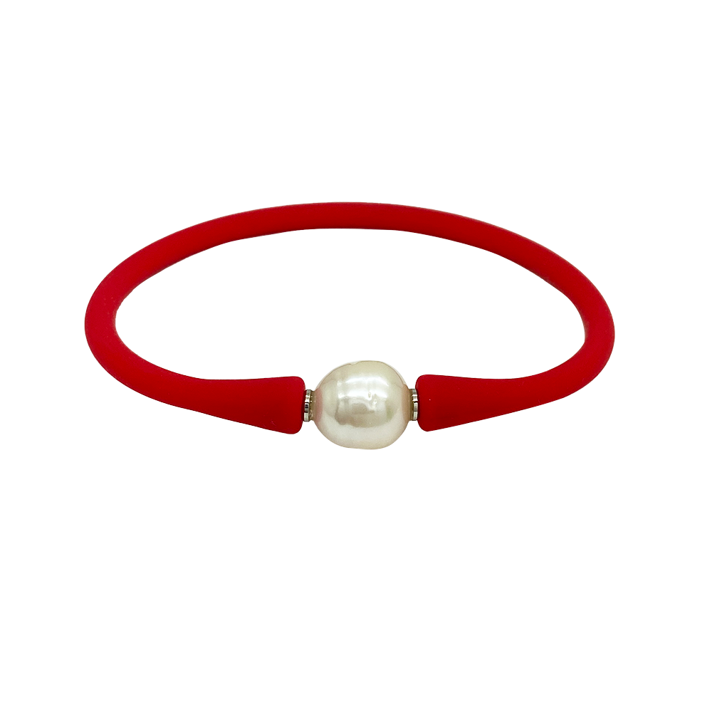Bracelet with a single white pearl in the center. The bracelet is made of a rubber-like material .