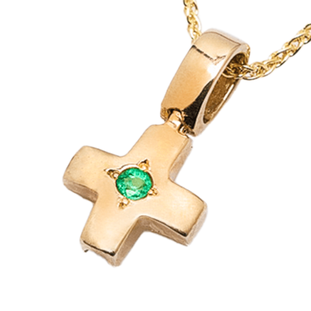 Gold cross pendant with a center gemstone on a white background