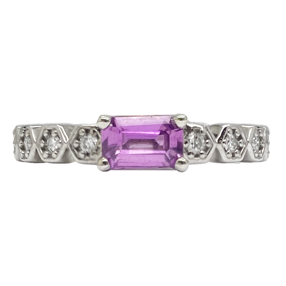 Platinum ring featuring an emerald-cut pink sapphire flanked by alternating diamond and platinum V-shaped motifs.