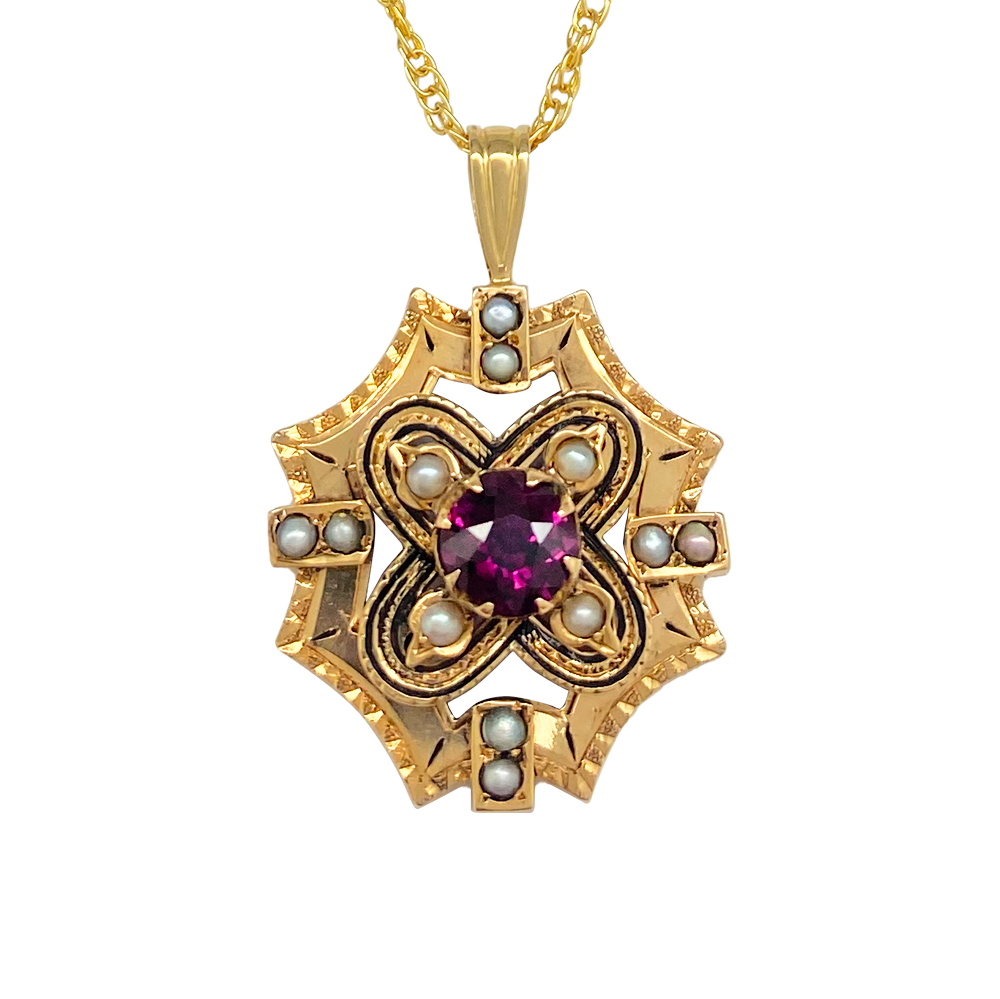 Gold pendant featuring a central garnet surrounded by a geometric design of pearls.