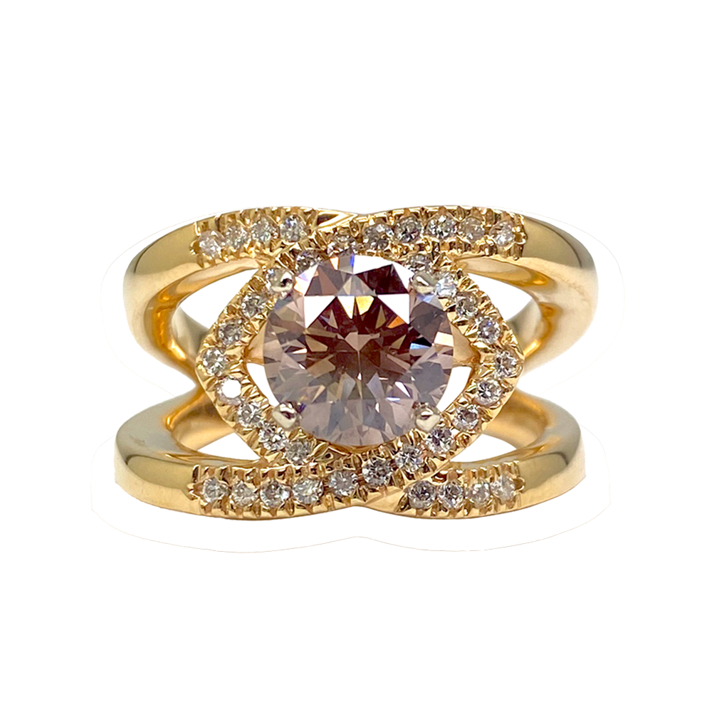 Gold ring with a large, round champagne diamond in a halo setting.