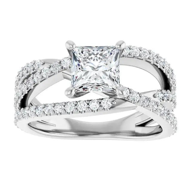 Diamond ring with a central princess-cut diamond and smaller diamonds on the band against a white background