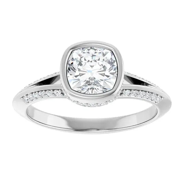 Silver ring with a large diamond and smaller diamonds on the band against a white background
