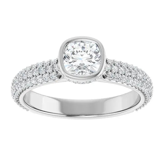 Silver ring with a large central diamond and smaller diamonds on the band against a white background