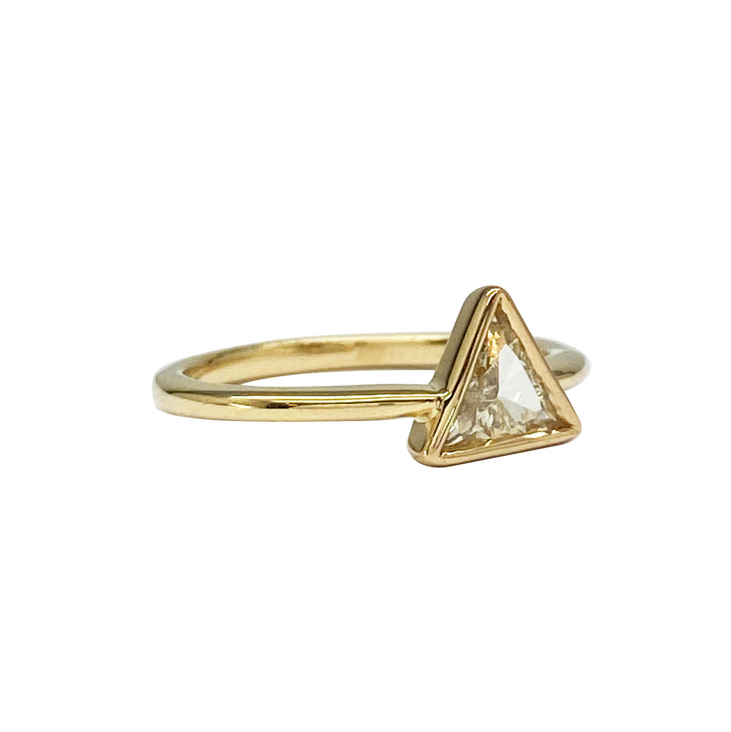 Yellow gold solitaire ring with a bezel-set natural triangle diamond.