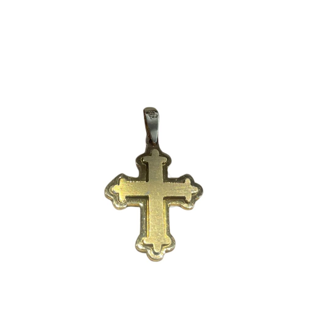 Gold cross pendant on a white background