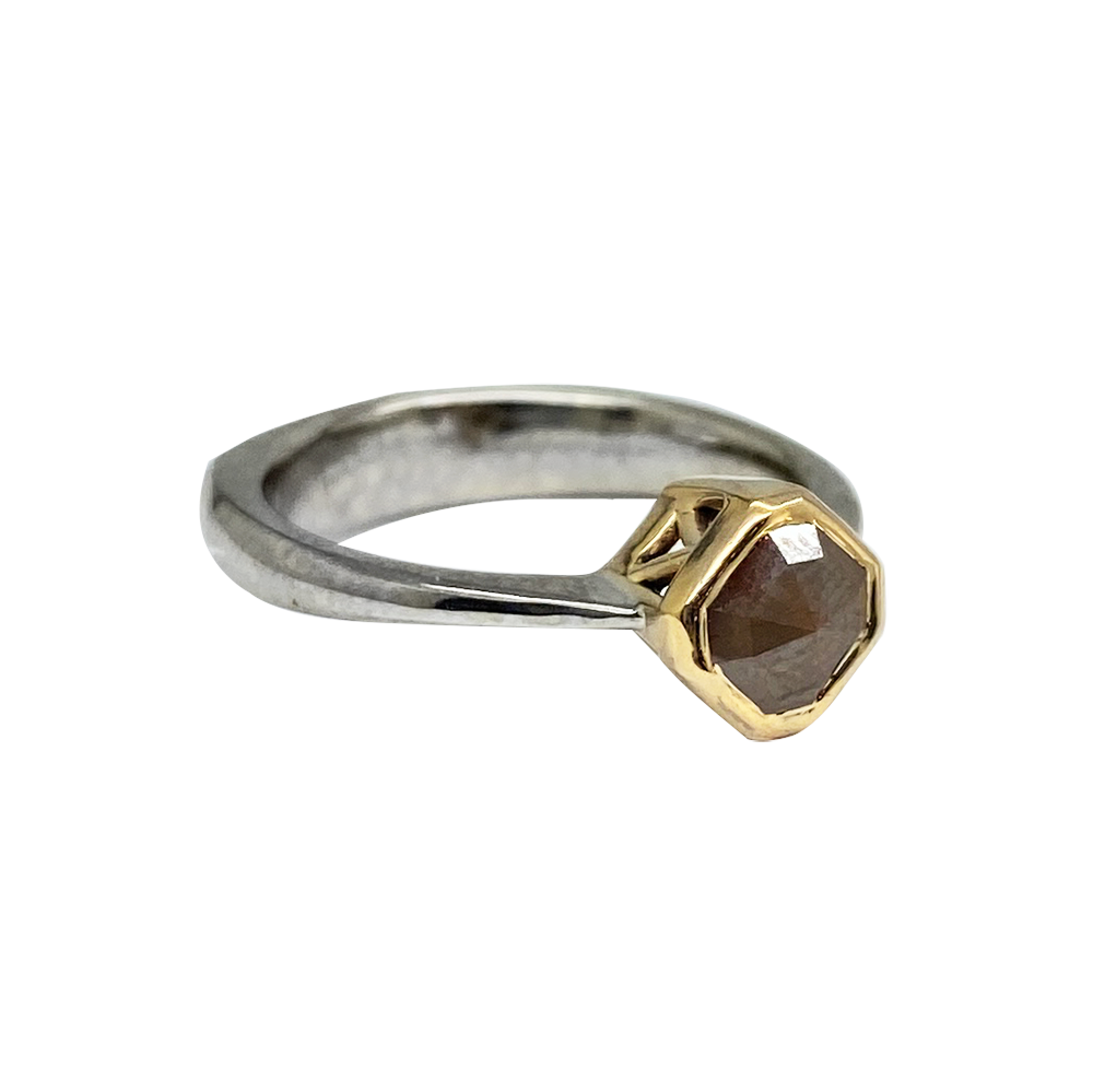 Hexagon-shaped salt and brown diamond ring with a mixed metal band featuring white gold and yellow gold.