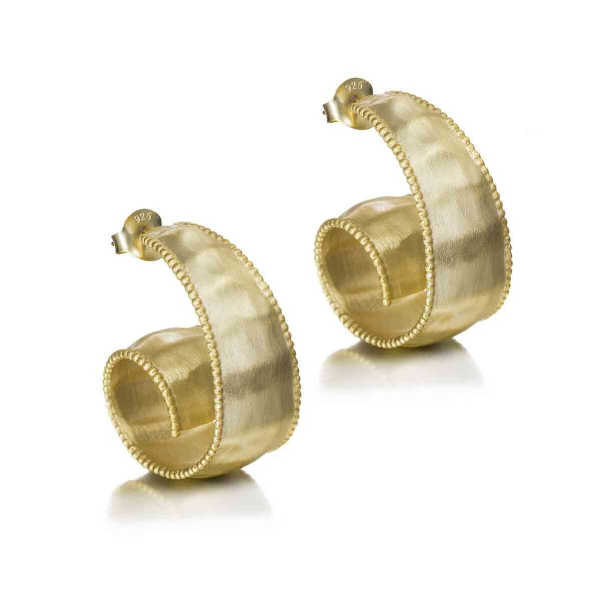 Gold hoop earrings on a white background