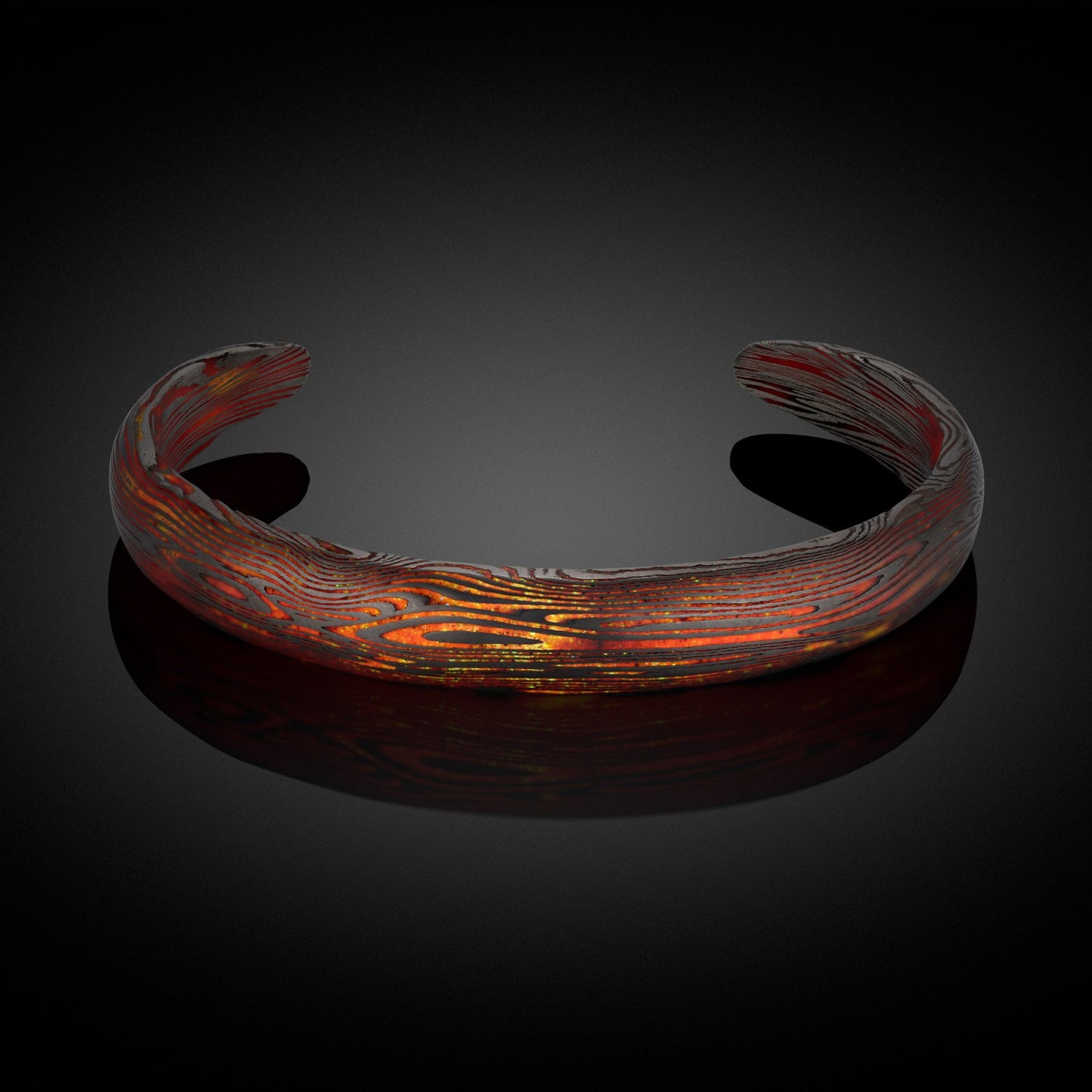Glow in the dark cuff bracelet with Damascus steel pattern on a white background.