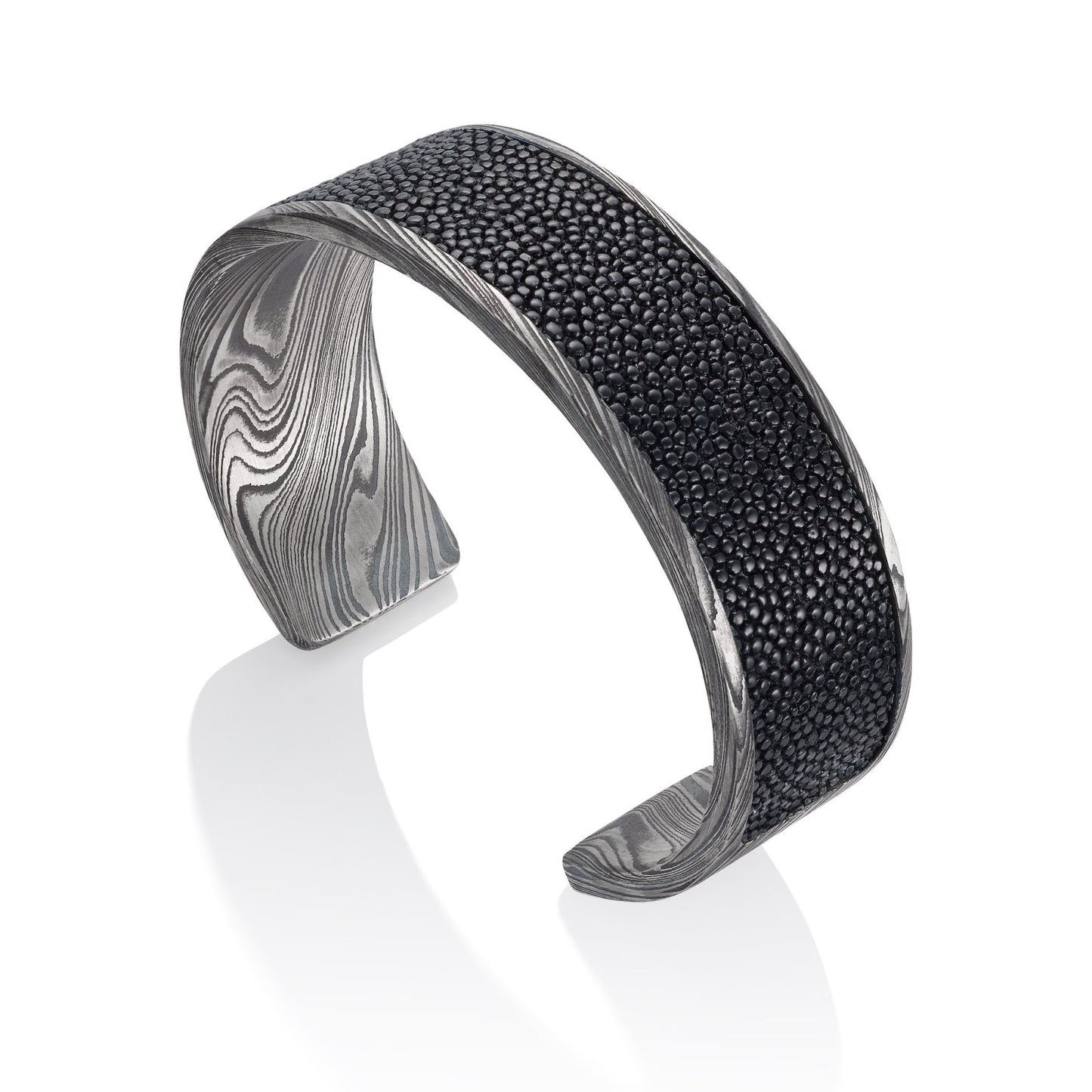 Titanium cuff bracelet with Damascus steel pattern on a white background.