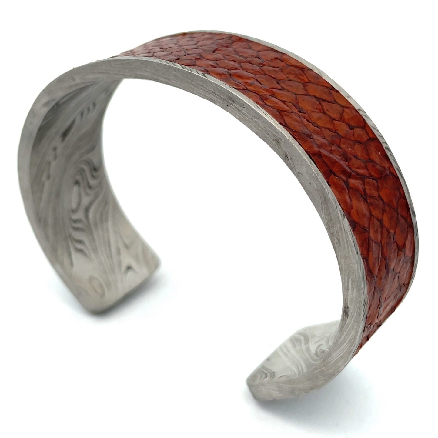 Titanium cuff bracelet with Damascus steel pattern on a white background.