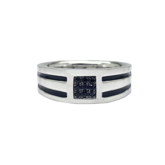 Silver ring with a black onyx stone set in a square frame. The ring is surrounded by a row of small black diamonds. The background is white.