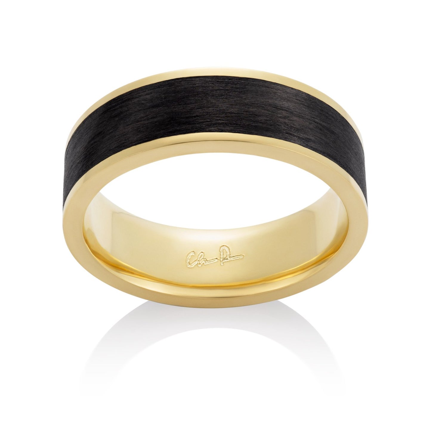 Yellow gold ring with a black carbon fiber inlay, on a white background.