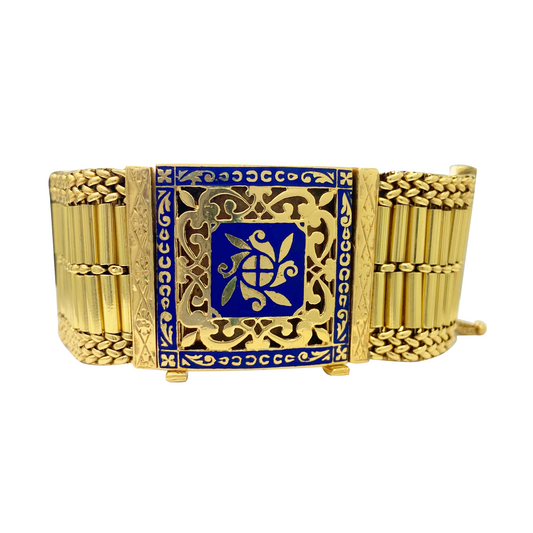Gold bracelet with blue center and turtle design on a white background