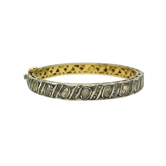 Gold and silver bracelet on a white background