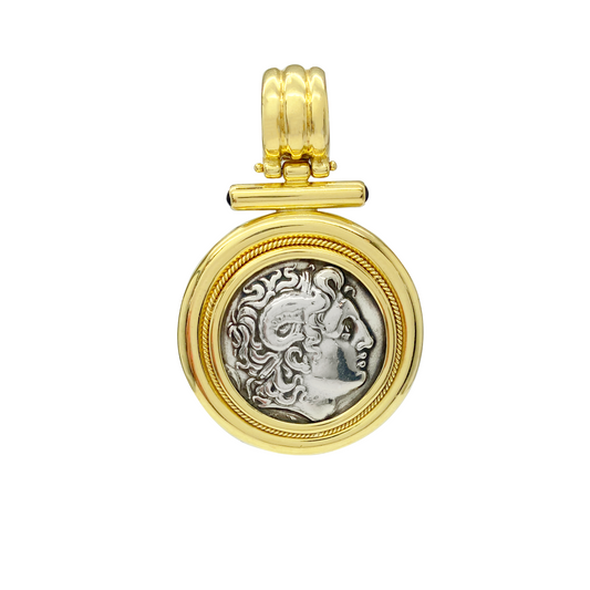 Gold pendant with a coin insert on a white background
