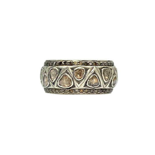 Silver ring with embedded stones on a white background