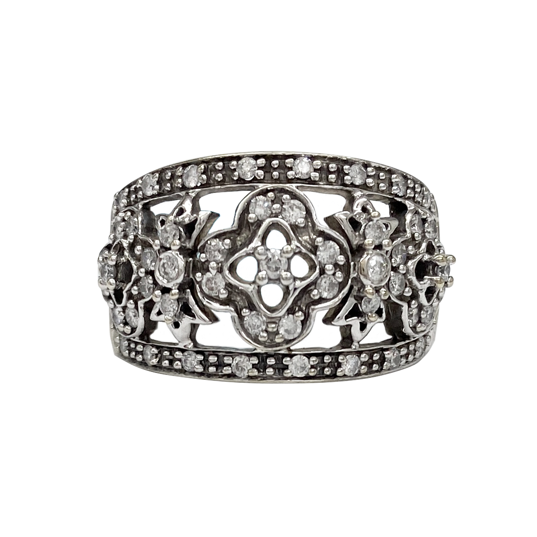 Ring with floral design and embedded stones on a white background