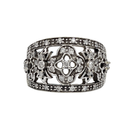 Ring with floral design and embedded stones on a white background