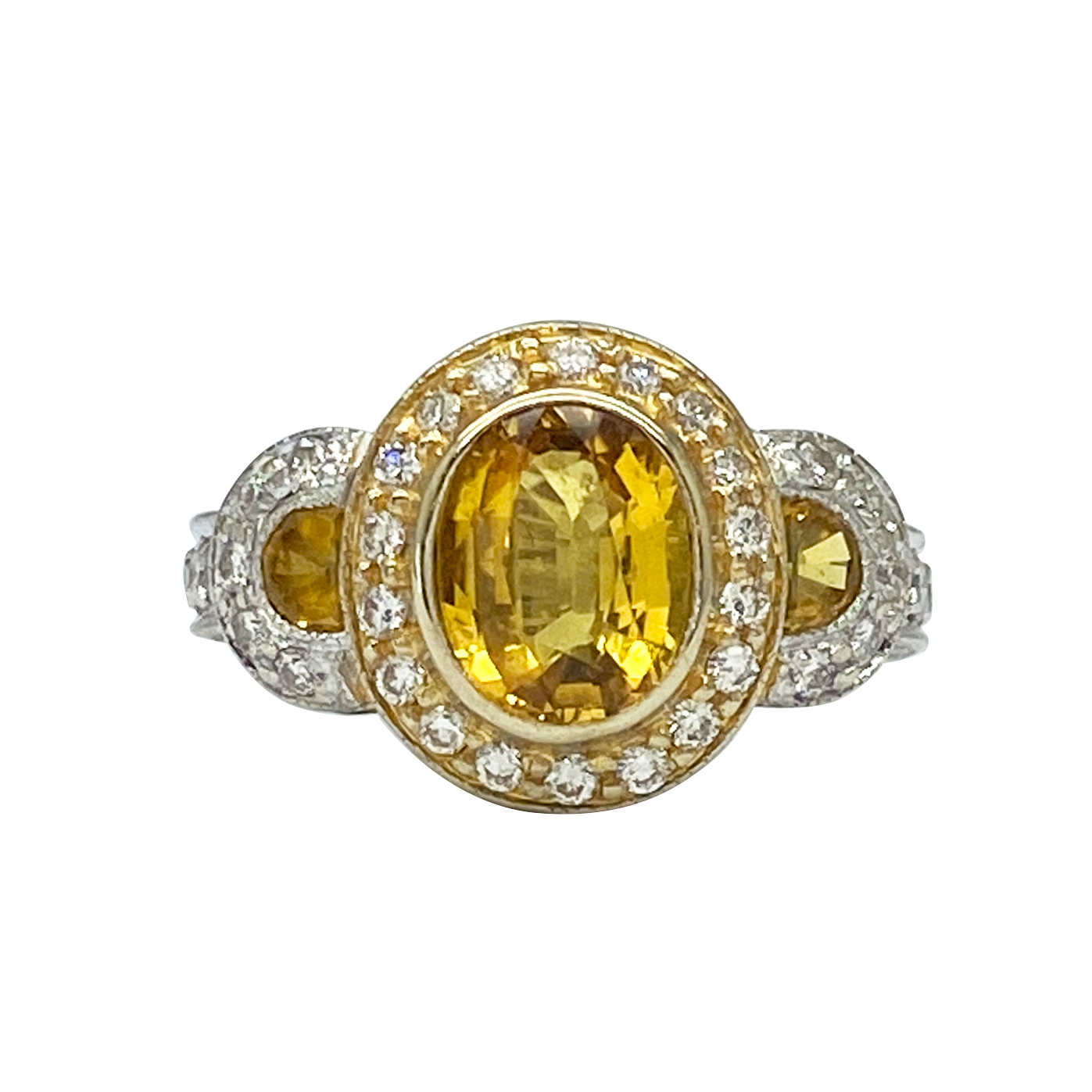 Gold and silver ring with a yellow gemstone on a white background
