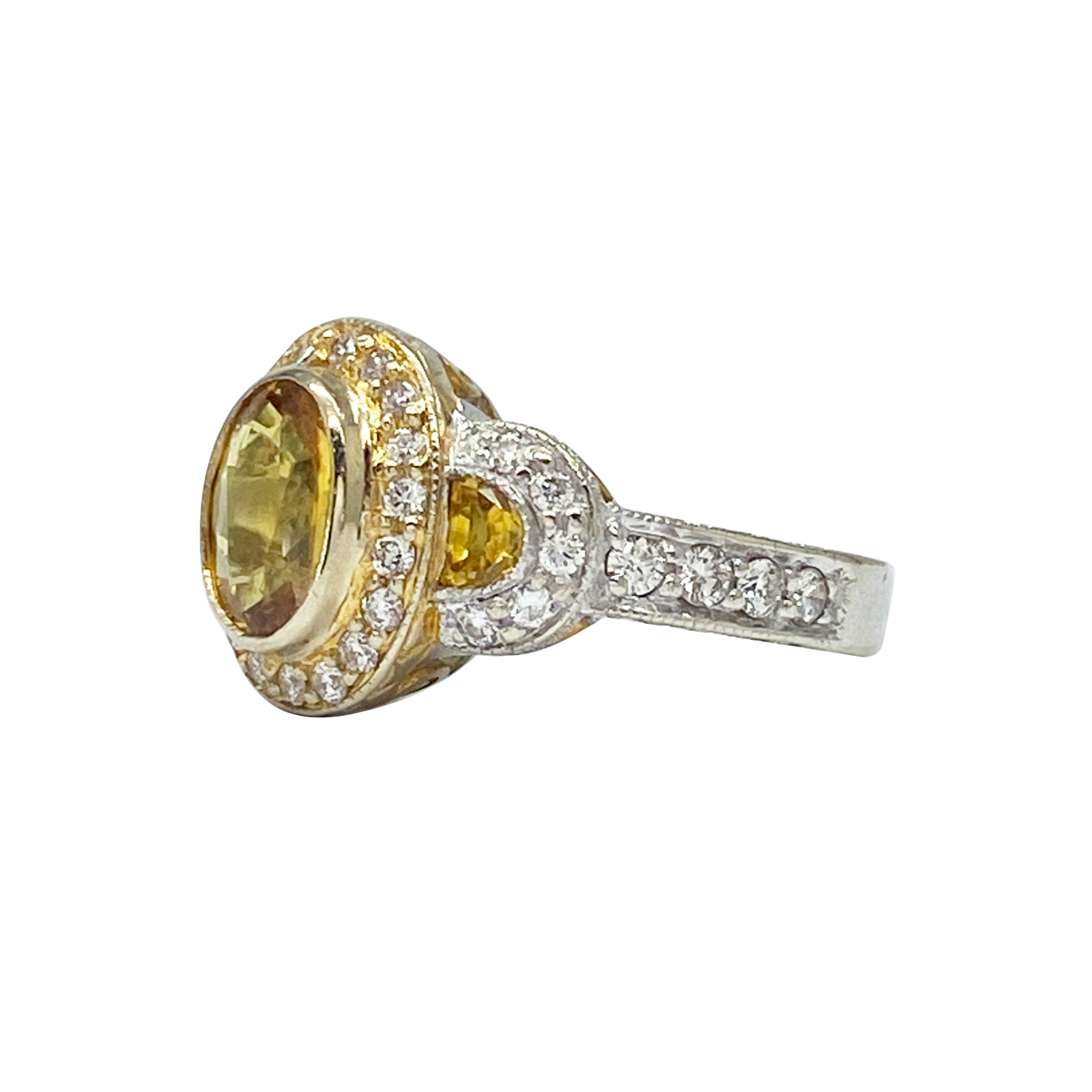 Ring with yellow gemstone and diamond accents on a white background