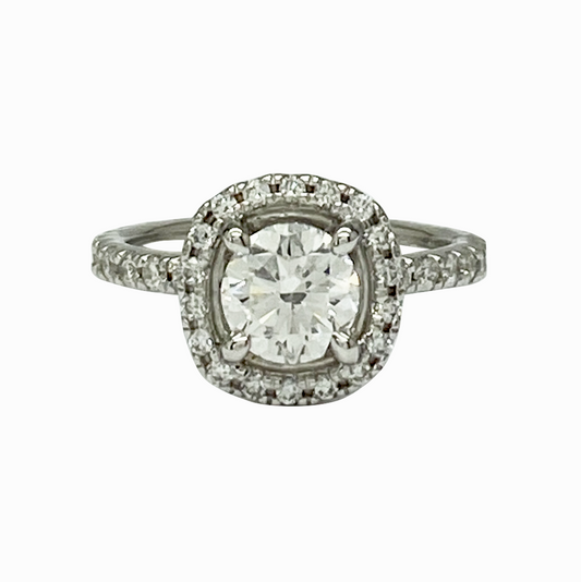 Diamond ring with a halo on a white background