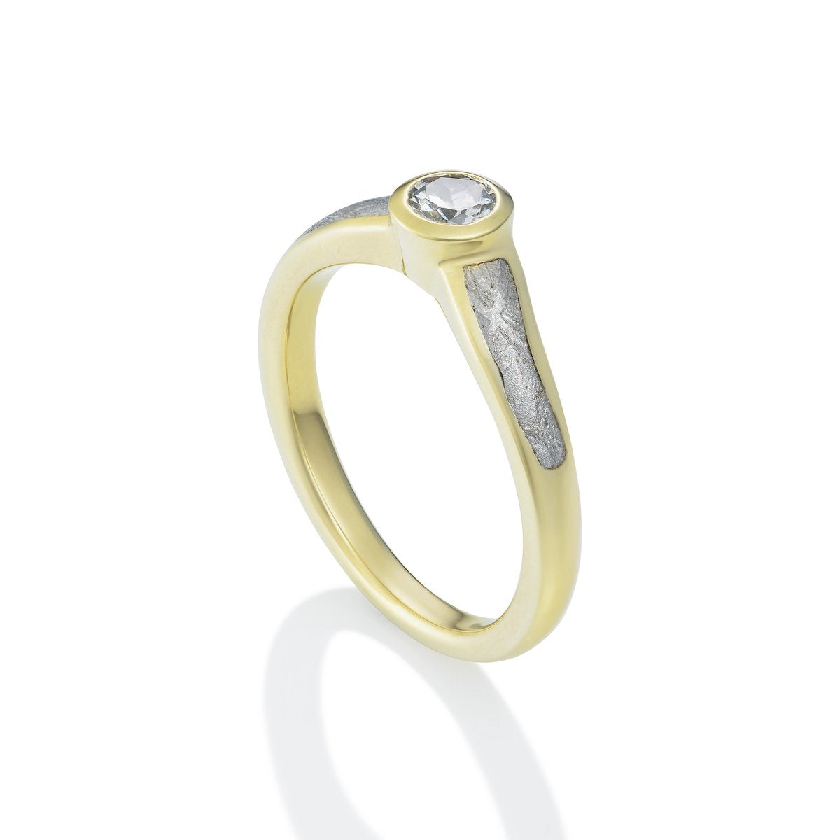 Yellow gold ring with a round diamond and a textured band on a white background.