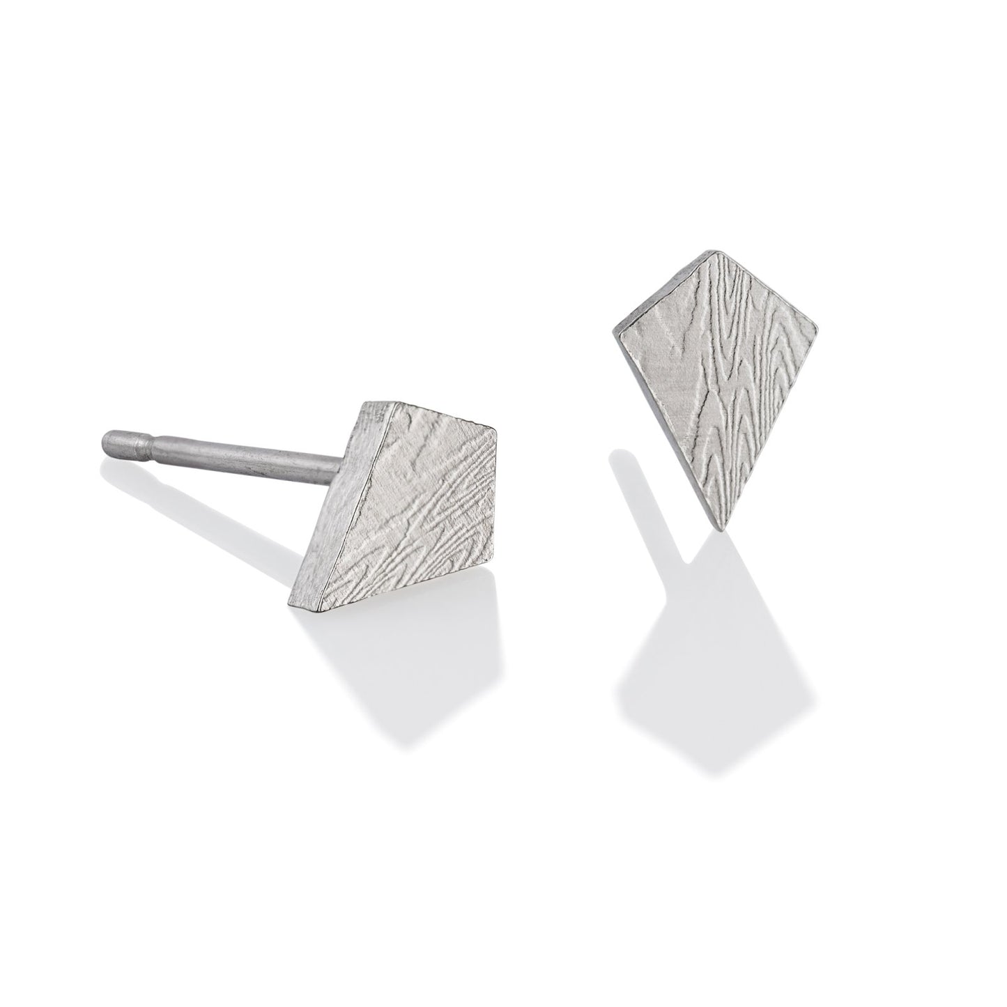 Pair of silver stud earrings with a damascus steel pattern, on a white background.