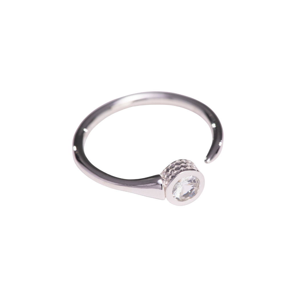 Silver golf T ring with a central diamond on a white background