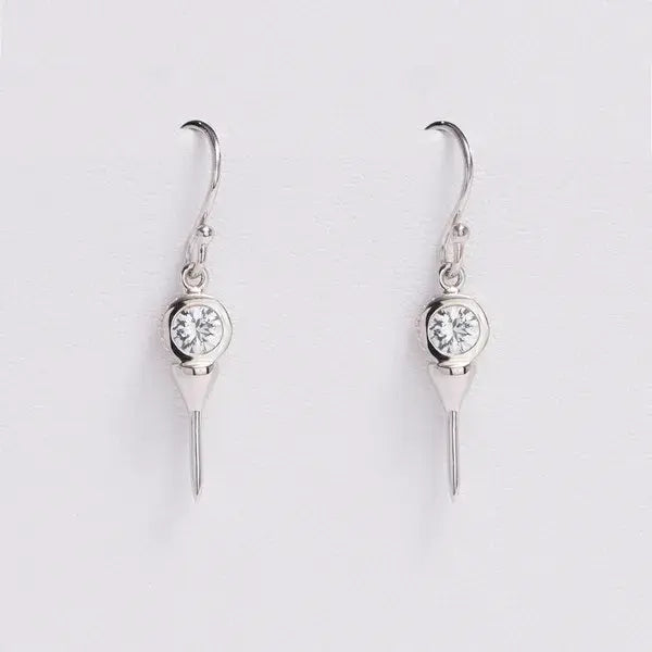 Pair of silver earrings with clear gemstones on a light gray background