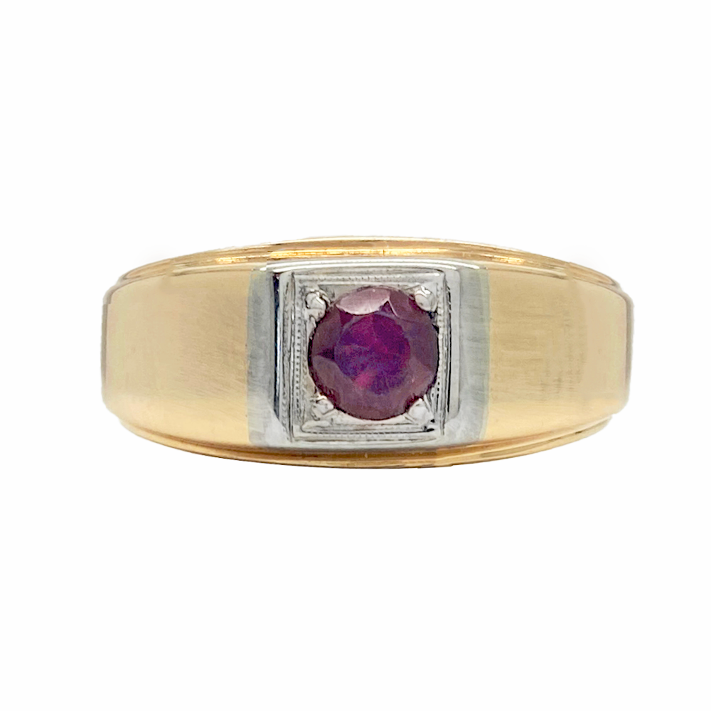 Two-tone men's ring with a red oval gemstone in the center. The ring has a wide band with a flat top and a grooved edge.