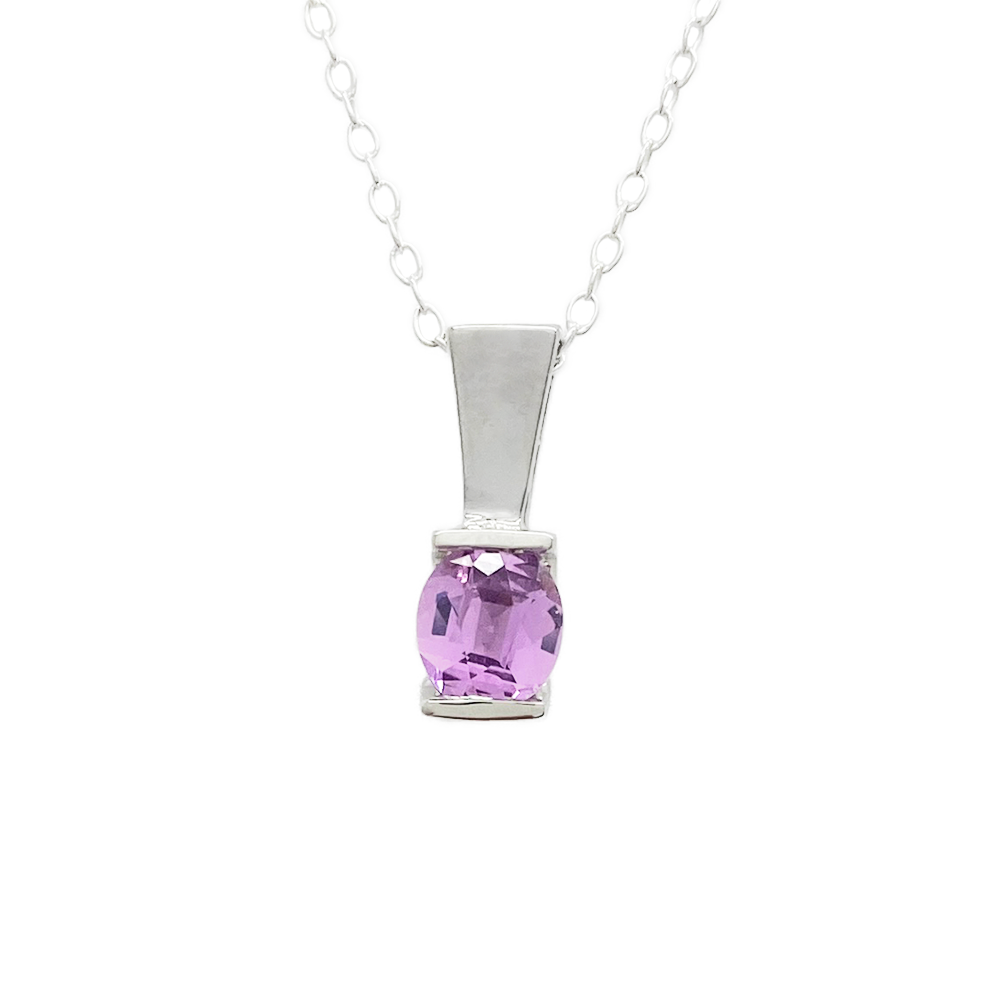 Silver necklace with a round, purple gemstone pendant has square-shaped setting.