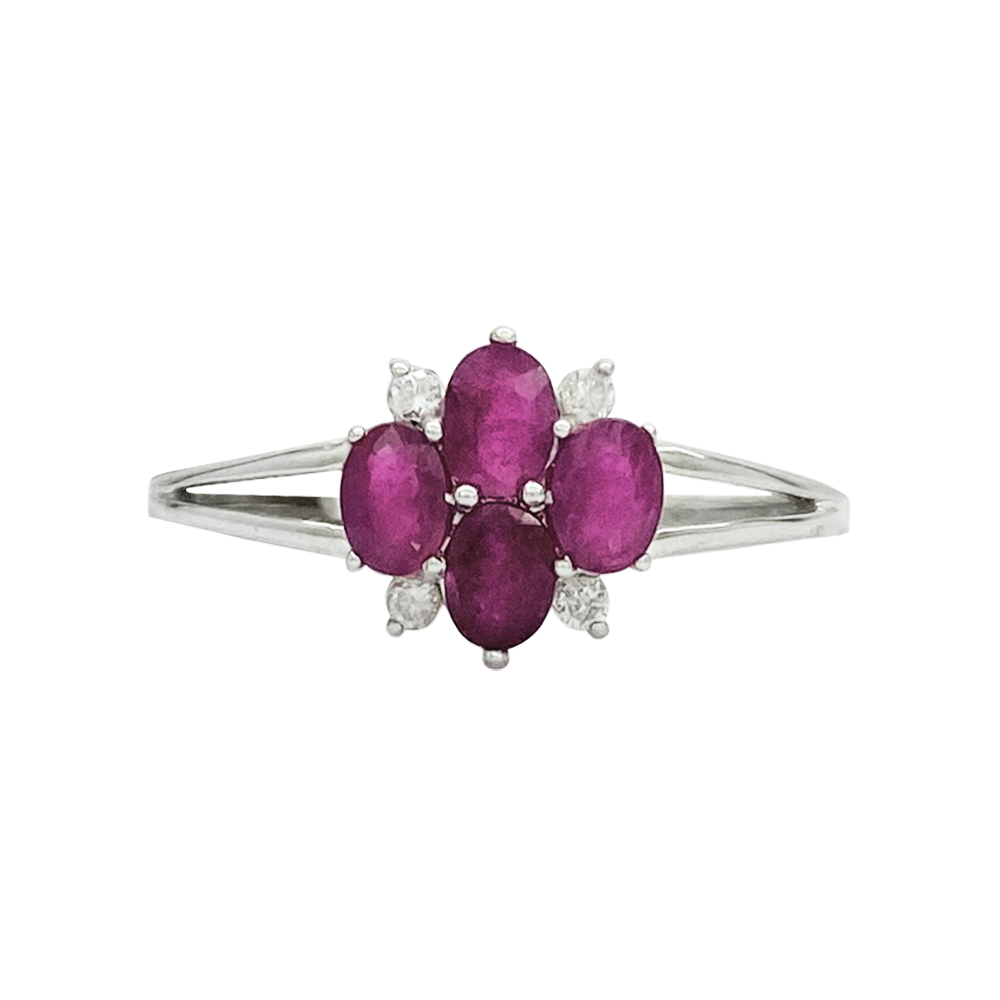 Front view of silver ring with a floral design featuring multiple rubies and diamonds on a white background