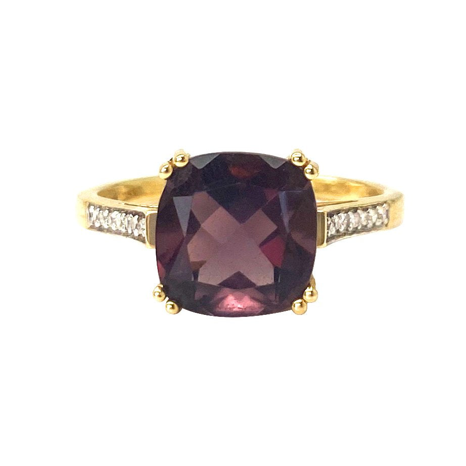 Gold ring with cushion-cut rhodolite garnet and diamond accents.