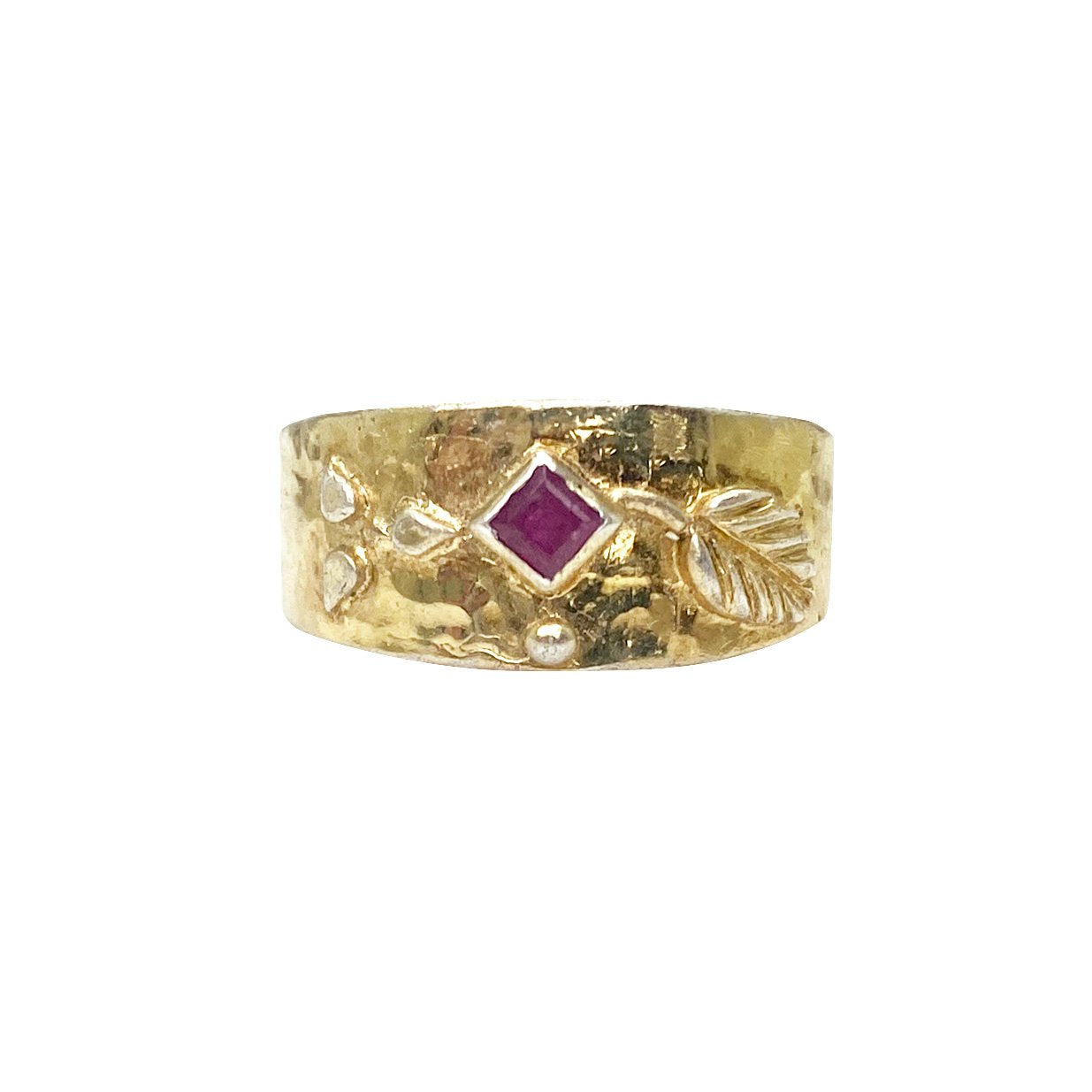 Hammered gold ring with ruby and silver accents.