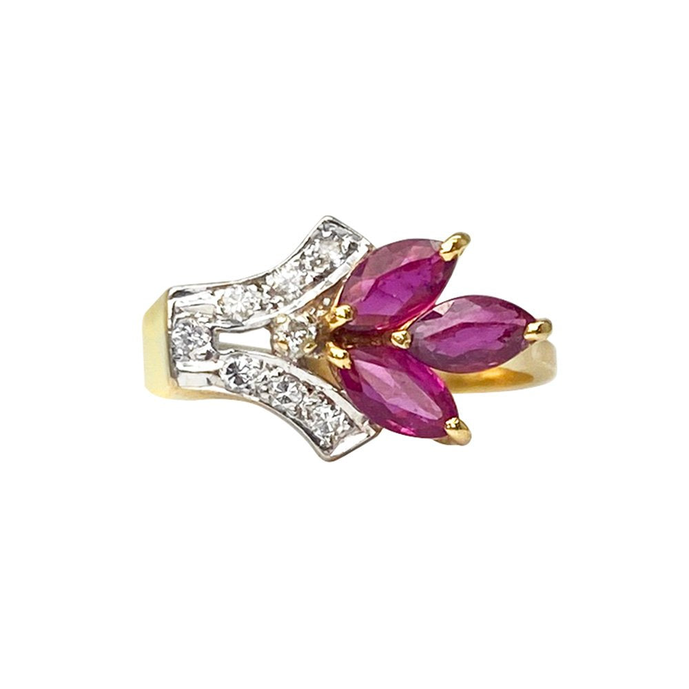 Gold ring with a cluster of marquise-shaped rubies and diamonds. The ring is set in a classic prong setting and is surrounded by a delicate rope border.