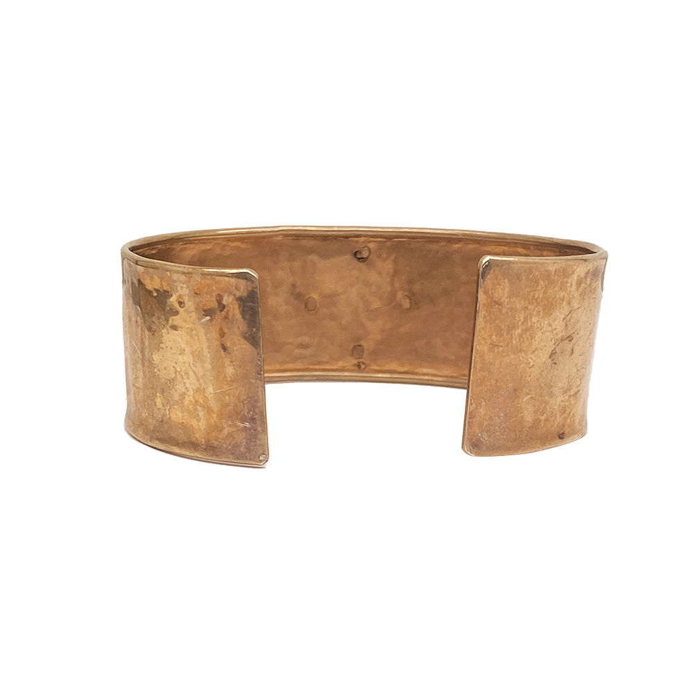 Copper or brass cuff bracelet with a hammered, textured finish.