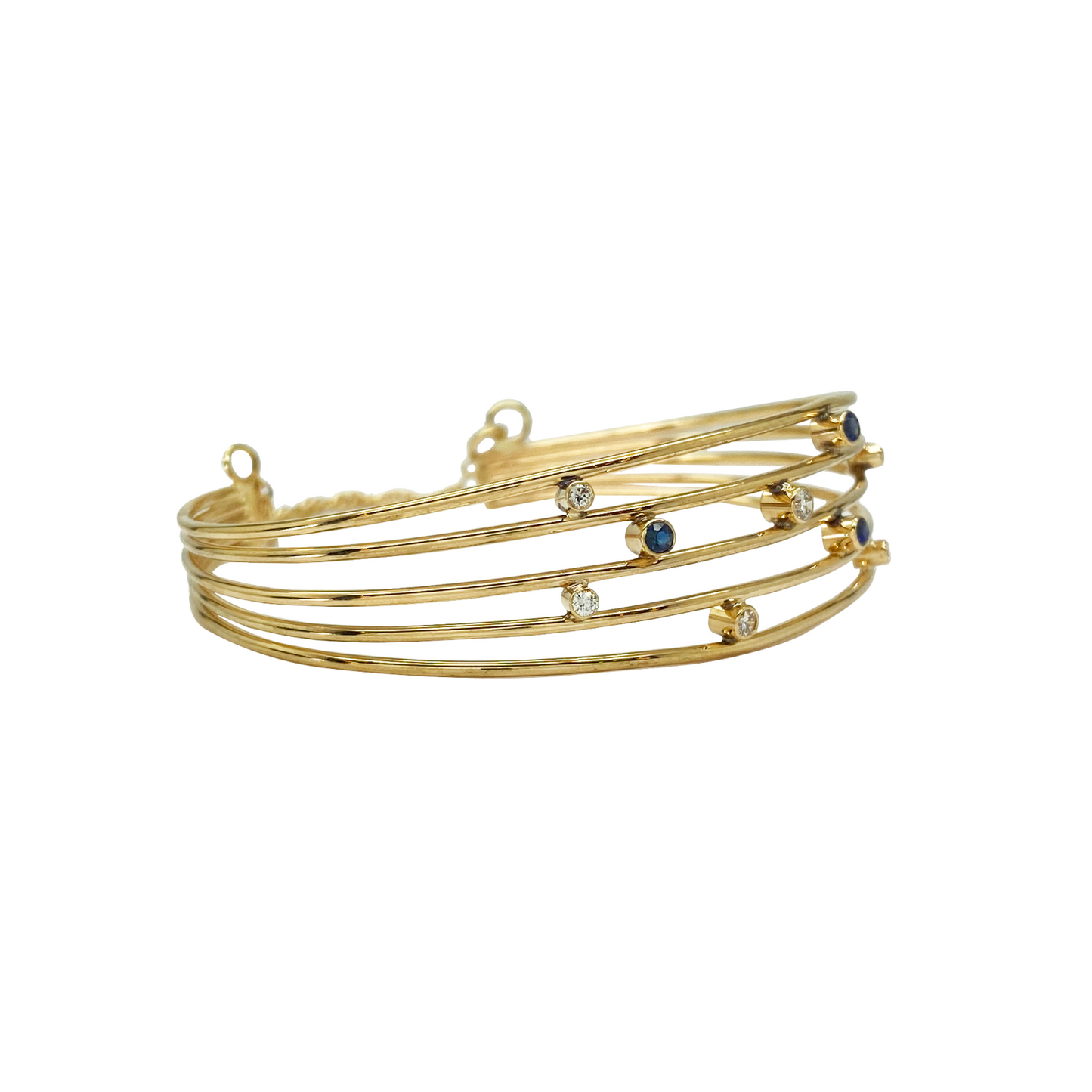 Multi-strand gold bangle bracelet with blue and clear beads.