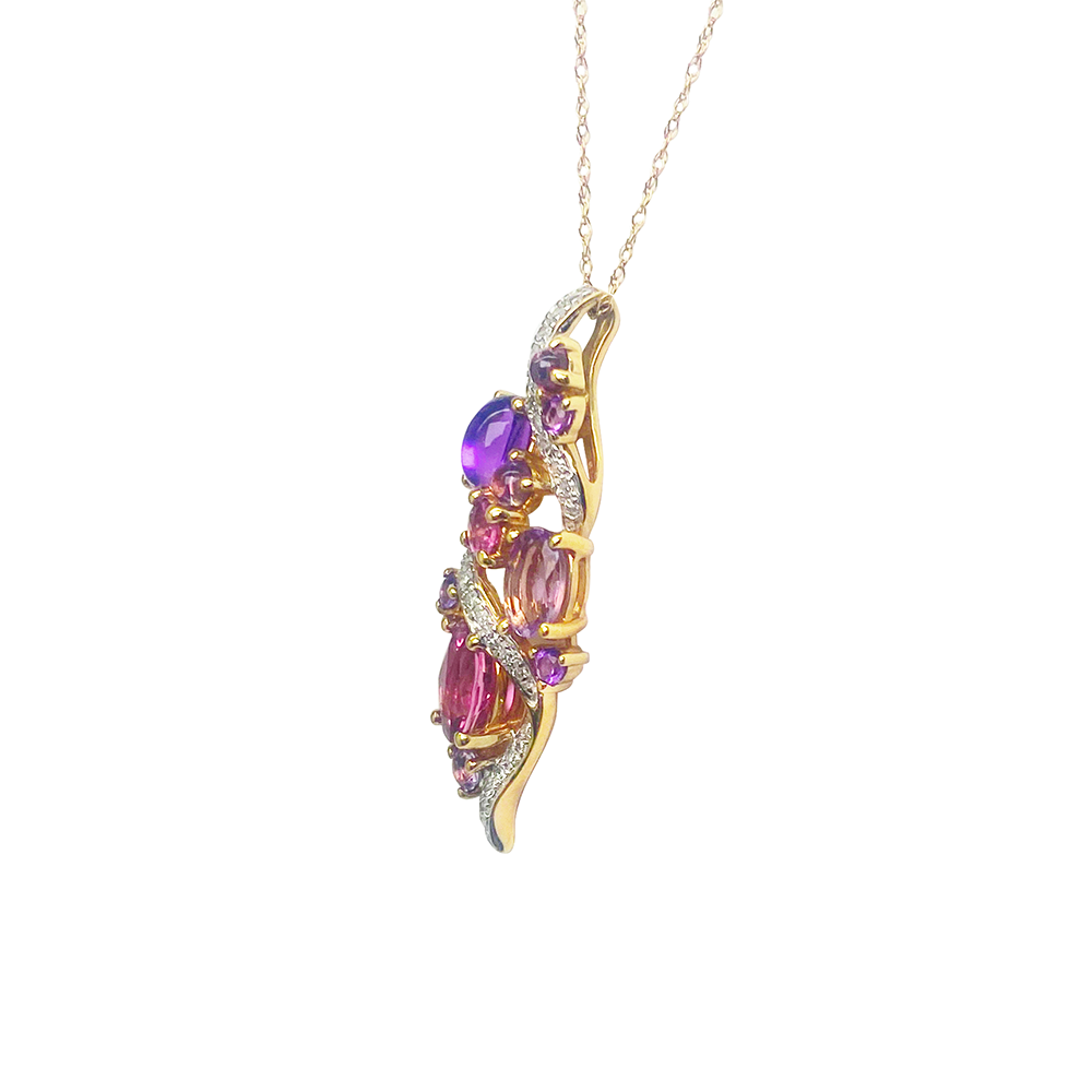 Gold necklace with a multi-stone pendant on a white background