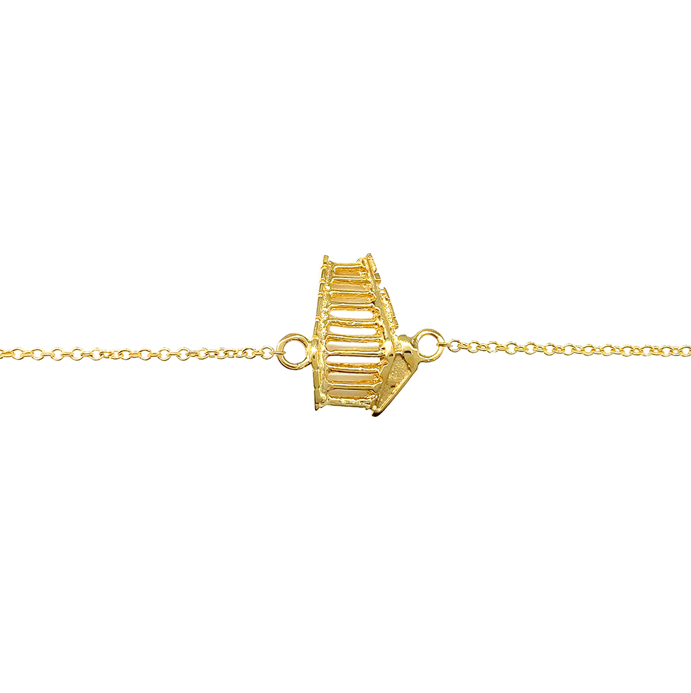 Gold bracelet featuring a unique, architectural design, on a white background