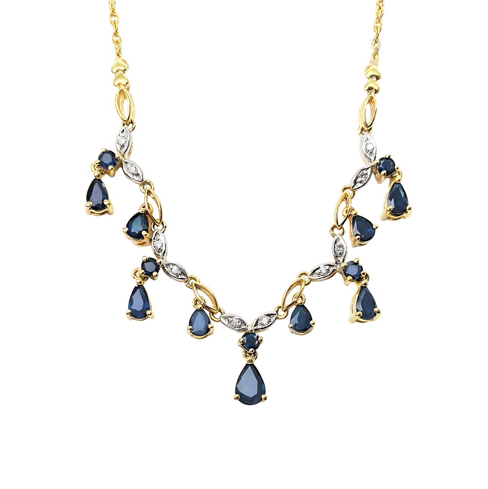 Yellow gold necklace with alternating pear-shaped sapphires and diamonds on a white background.