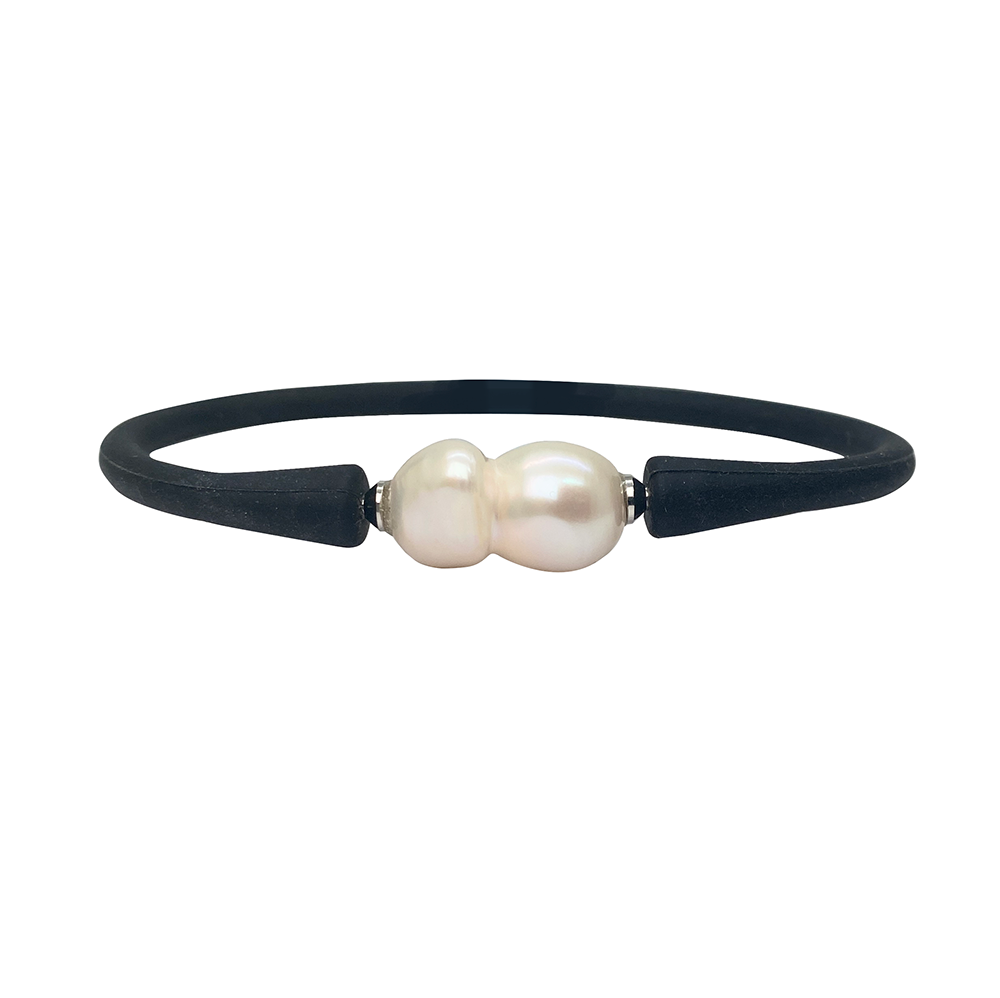Black silicone bracelet with a large, baroque pearl in the center.