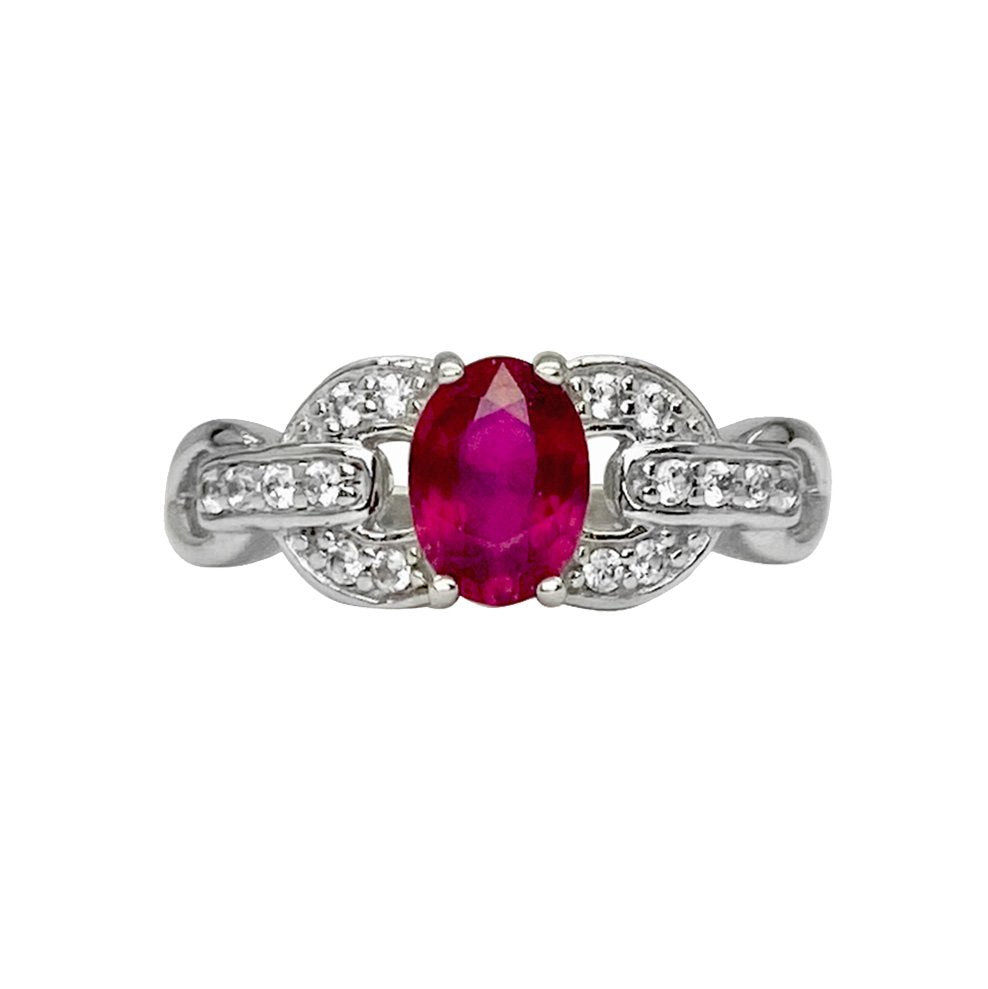 Silver ring with an oval ruby stone surrounded by diamonds. The ring is set in a delicate, linked design. The background is white.