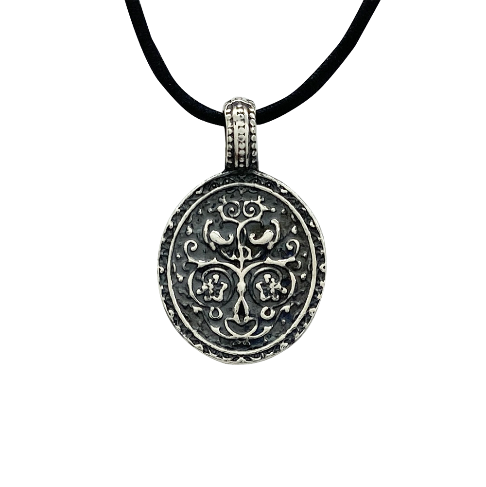 Silver pendant featuring a religious icon of Saint Nicholas, on a whitebackground.