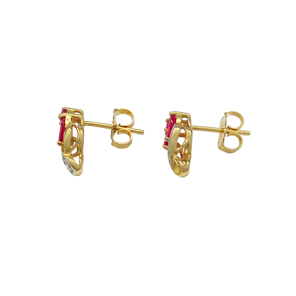 Yellow gold stud earrings with marquise-shaped ruby gemstones and diamond accents, on a white background.