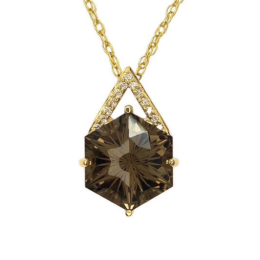 Gold pendant necklace featuring a hexagonal smoky quartz gemstone with a starburst pattern, accented by a diamond-studded V-shaped bezel.