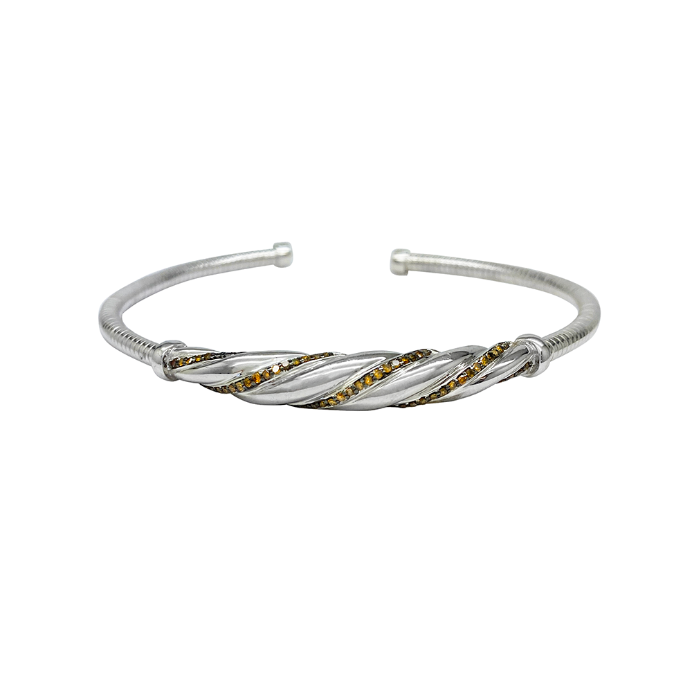 Silver bangle bracelet with a twisted design and yellow gemstones on a white background.