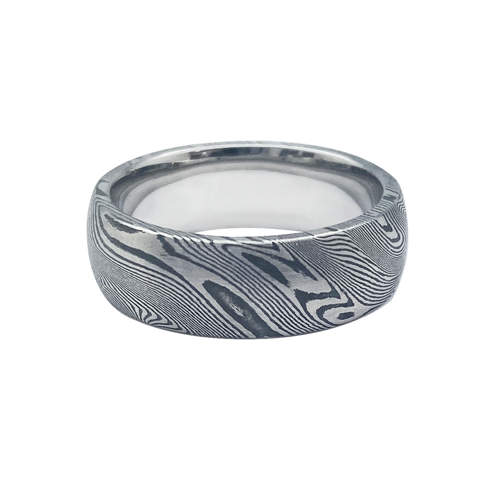 Silver ring with a Damascus steel pattern, on a white background.