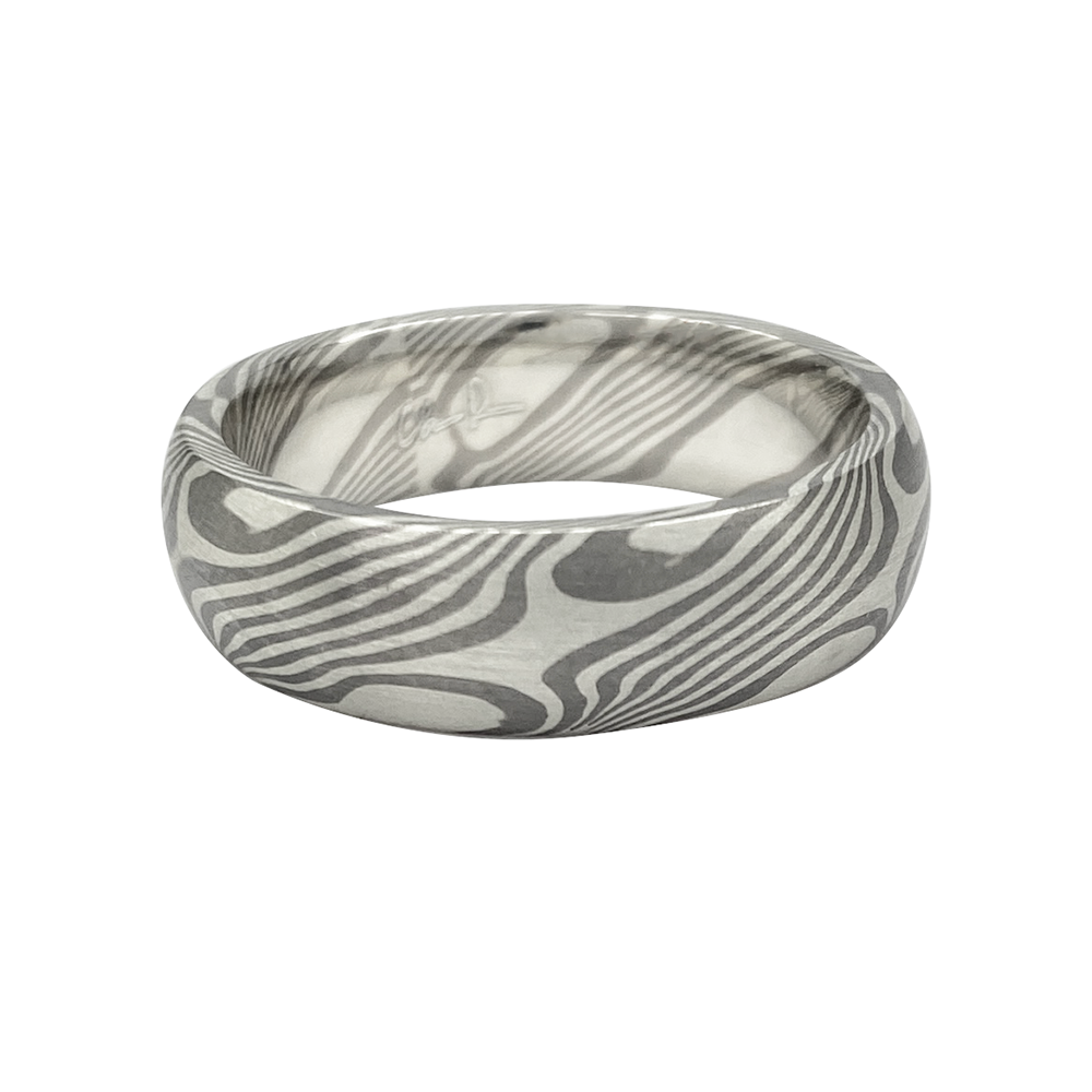 Silver ring with a Damascus steel pattern, on a white background.